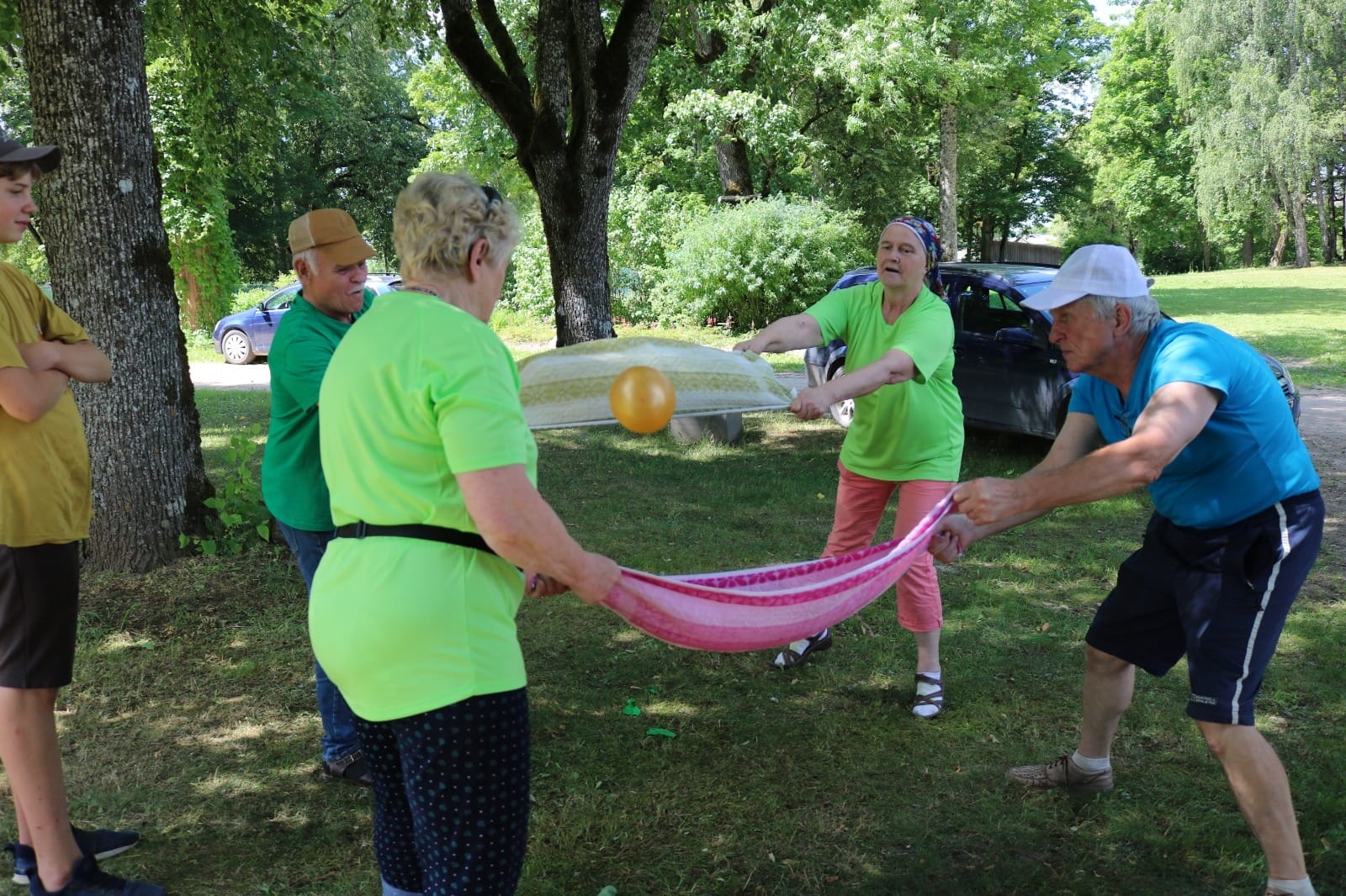 Seniori met balonu ar dvieļu palīdzību